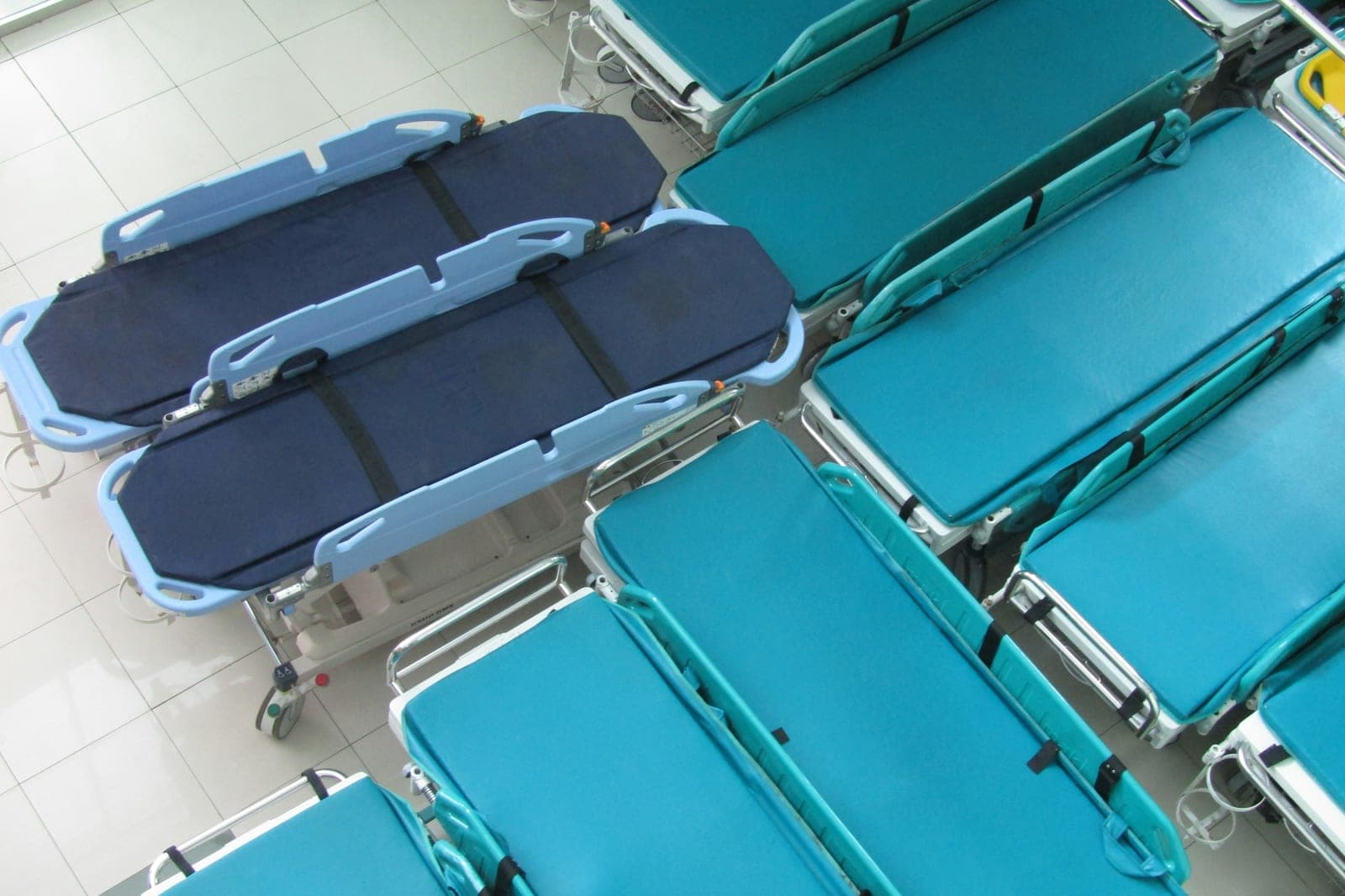 Leere Patiententragen, nebeneinander aufgereiht
